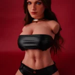 ULW 663# Emma: This front-view photo captures the doll's detailed torso featuring striking blue eyes and long wavy dark hair, wearing a black leather bandeau top that highlights her fair, smooth realistic skin and full curves against a red backdrop.