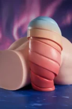 This front-perspective shot displays the product laid flat, focusing on the sculpted tail cascading from the top to clearly present its light blue to pink gradient colors and layered spiral textures.